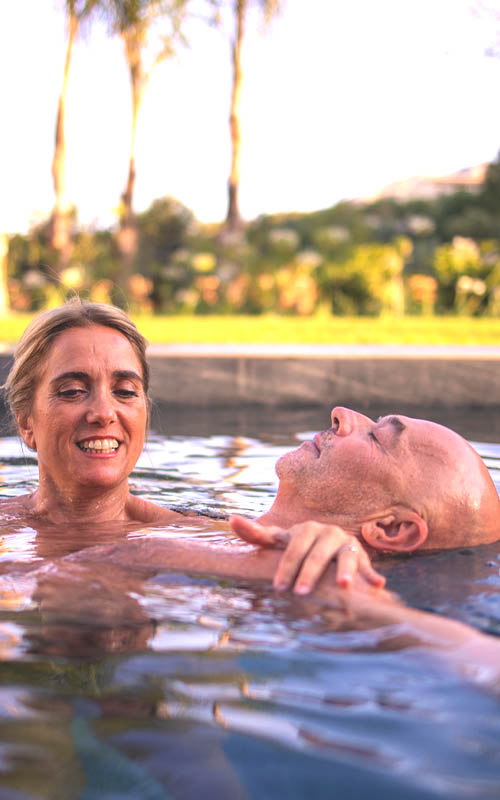 Mónica supporting Peter in a mindful water-based tantra practice, Connective Tantra School