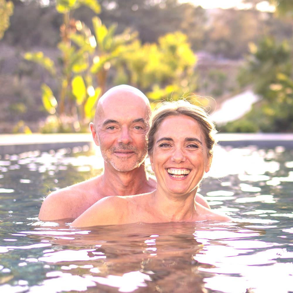 Monica and Peter of Connective Tantra School smiling in the water: connection, intimacy, and Sacred Union